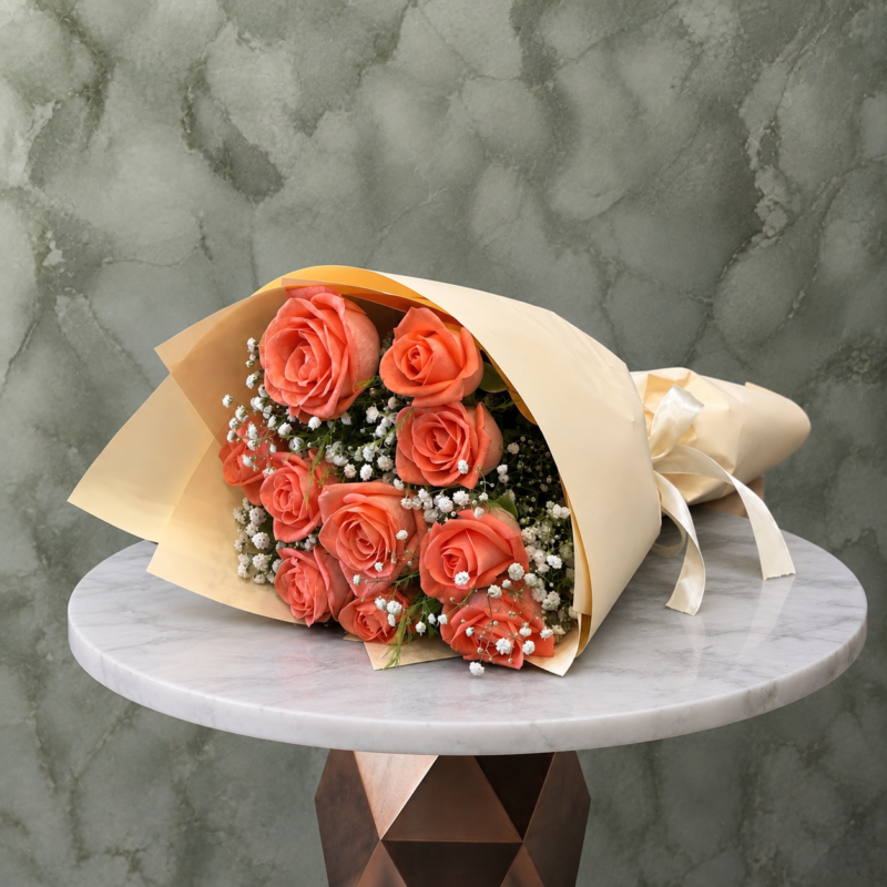 Orange roses amman featuring vibrant peach roses and white baby's breath in elegant beige wrapping paper.جوري الأورنج