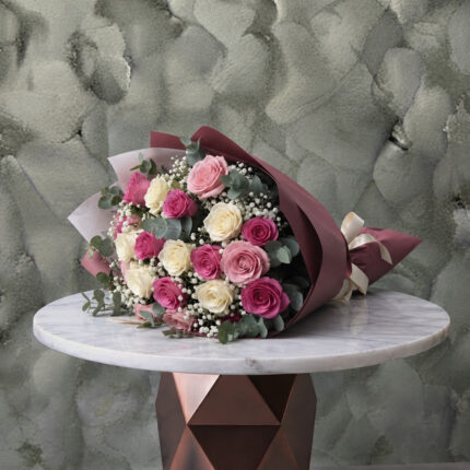 Pink and white roses bouquet amman featuring vibrant pink and cream roses with baby's breath and eucalyptus in elegant wrapping.