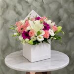 صندوق صيف سعيد يحتوي على زهور جيربيرا وليليوم وبيبي روز في عمان-A happy summer box filled with colorful gerberas, lilies, and pink roses in Amman.
