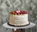 Fresh strawberry cake amman from Cake Shop decorated with whipped cream and fresh strawberries on a table.