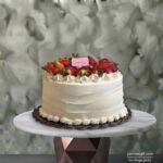 Fresh strawberry cake amman from Cake Shop decorated with whipped cream and fresh strawberries on a table.