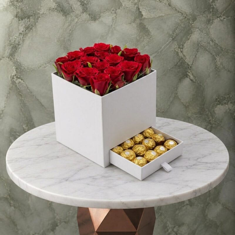 بوكس التميز ورد وفيريرو روشيه يحتوي على 16 وردة حمراء و12 قطعة فيريرو في عمان-White lovely box roses ferrero featuring 16 red roses and 12 Ferrero Rocher chocolates in Amman.