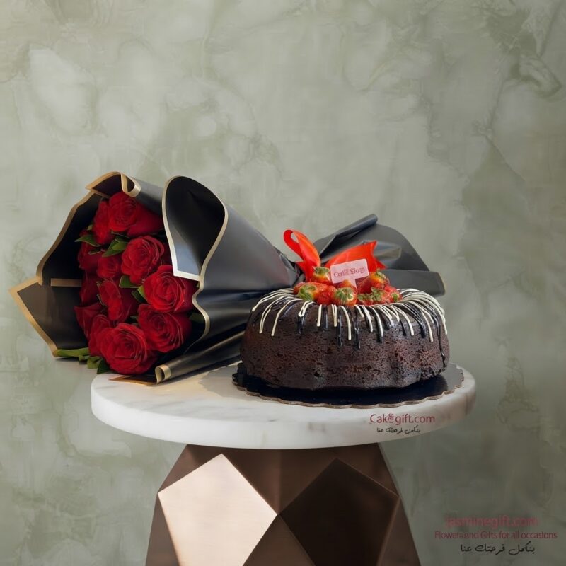 Red roses with chocolate cake topped with fresh strawberries and black luxury wrapping paper.
