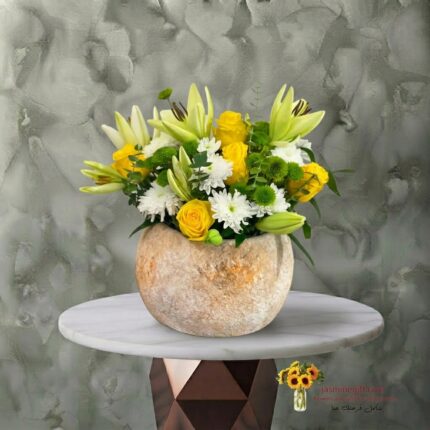 Daily flowers in a stone jar with yellow lilies and roses in Amman-زهور يومية في جار حجري