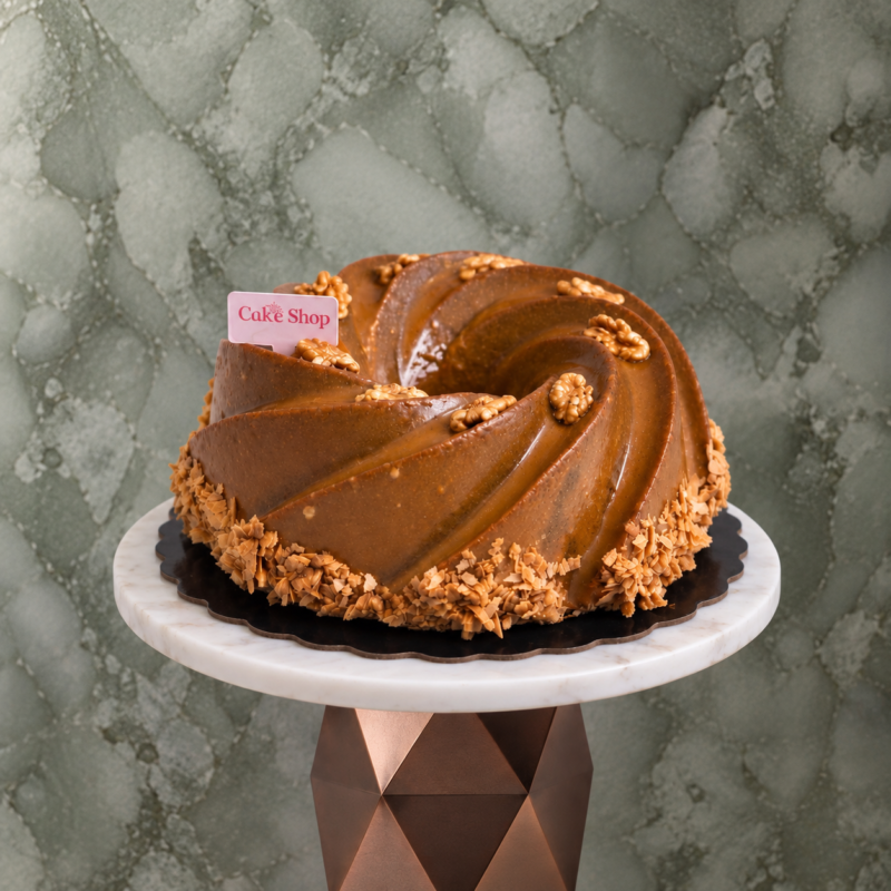 Dates cake amman covered with rich caramel sauce and garnished with walnuts and a chic presentationكيك التمر في عمان