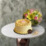 Flowers with chocolate tiramisu cake in a glass bowl from Cake Shop in Amman-زهور مع كيكة شوكولاتة التيراميسو في فازة زجاجية من كيك شوب في عمان.