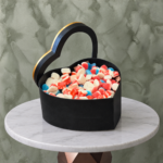 Black heart candy box amman featuring a 1kg assortment of colorful candies in a luxury heart-shaped box-بوكس قلب أسود كاندي في عمان