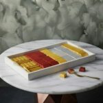 Rectangular chocolate box amman featuring 100 pieces of assorted luxury chocolates in a white tray