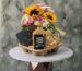 Coffee delightful gifts amman featuring bright sunflowers, iced caffe latte bottle, sweets box, and treats in a carrier.القهوة هدايا لذيذة عمان