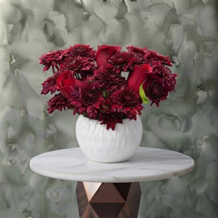 Eternal passion amman arrangement featuring a rich mix of fresh red roses and textured dark red chrysanthemums in a modern white ceramic pot.