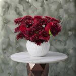 Eternal passion amman arrangement featuring a rich mix of fresh red roses and textured dark red chrysanthemums in a modern white ceramic pot.