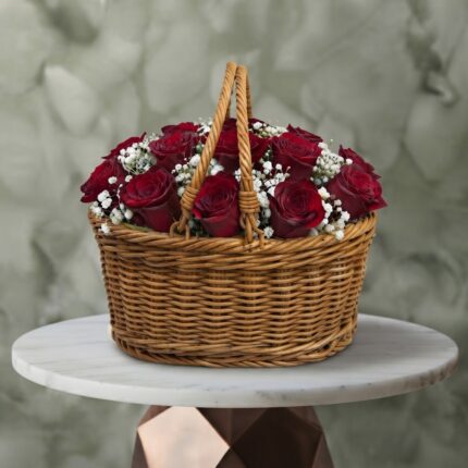 Twelve hearts amman red roses basket with 12 red roses and white baby's breath in a woven wicker basket with handles.