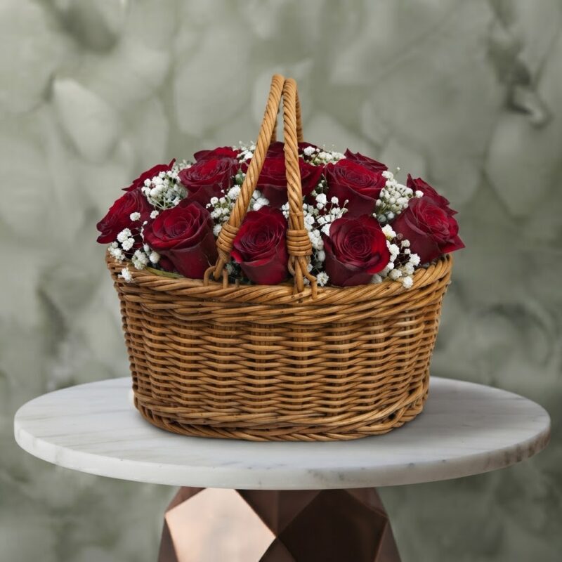 Twelve hearts amman red roses basket with 12 red roses and white baby's breath in a woven wicker basket with handles.