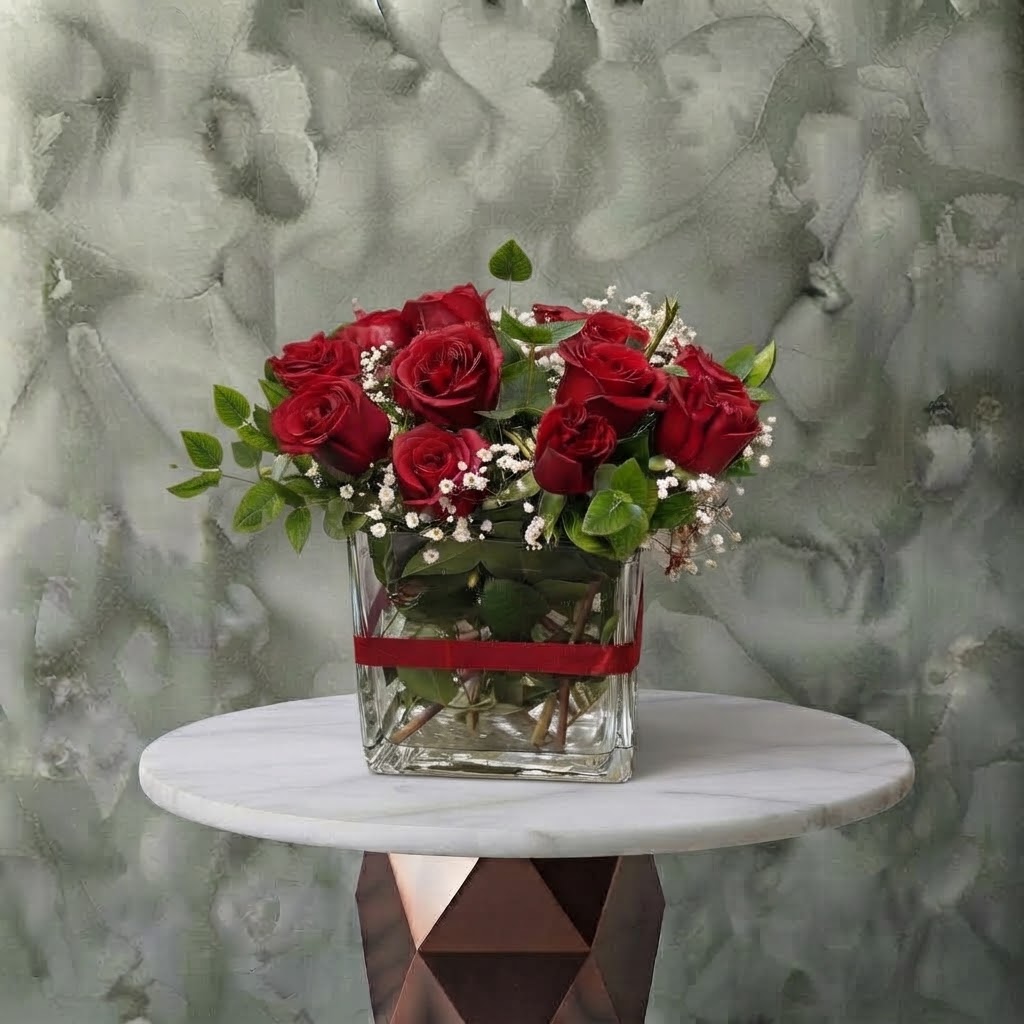 Classic Red - كلاسيك ريد Classic red amman arrangement featuring fresh red roses, white baby's breath, and greenery in a square glass vase tied with a red ribbon.كلاسيك ريد