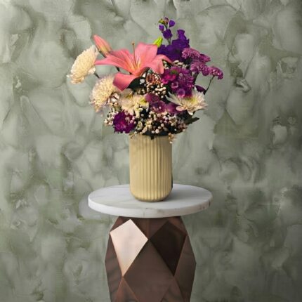 Gentle touch amman arrangement featuring pink lily and purple chrysanthemums in a yellow ribbed ceramic vase.