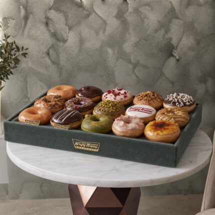 Krispy kreme donuts amman inside an elegant velvet tray on a marble table