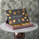 Alnejmah premium mixed baklava box 1000g displaying varieties-صندوق مشكل بقلاوة بريميوم من حلويات النجمة بوزن 1000 غرام