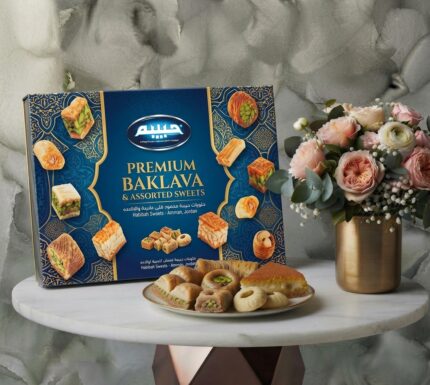 Premium box of Habiba Sweet with a pink flower arrangement and golden vase in Amman.